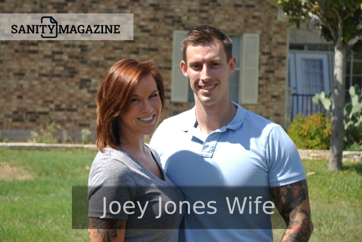 Joey Jones wife and Meg Garrison Jones smiling in front of a brick home.